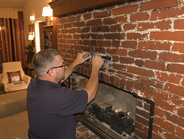 St. Simons Chimney Sweep expert fixing a fireplace in St. Simons, GA